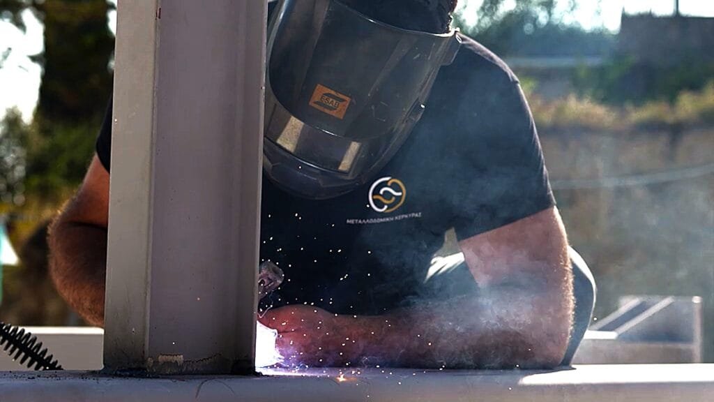 Expert welder from Metallodomiki Corfu working on a structural steel project. Contact us for custom metal constructions.