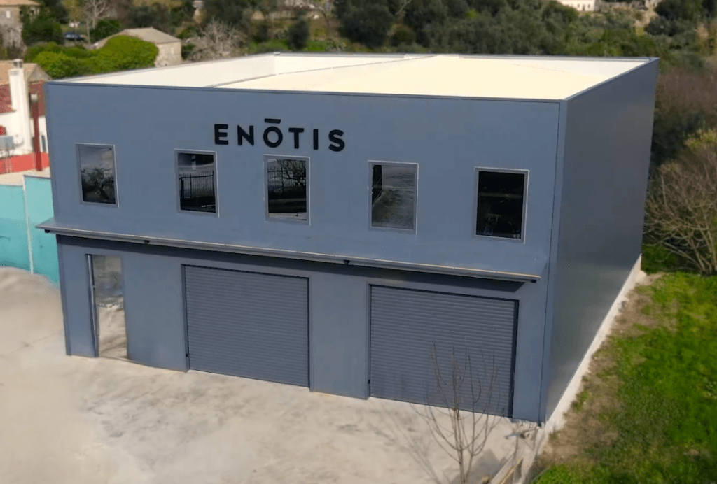 Completed commercial metal building "Enotis" featuring modern industrial panel cladding in Corfu.